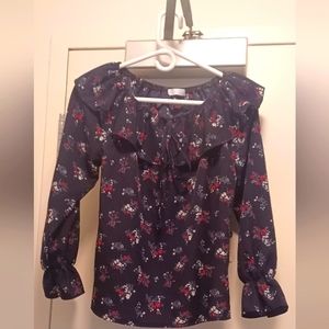 Long sleeved Navy flowered blouse with neck ruffle and small opening with a bow